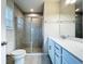 Bathroom with double sinks, white cabinets, quartz counters, glass shower, and tile flooring at 10347 Heron Hideaway Loop, Land O Lakes, FL 34638