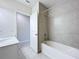 Bright bathroom featuring a tub and shower with modern fixtures at 10347 Heron Hideaway Loop, Land O Lakes, FL 34638