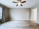 Bedroom with light colored wood flooring, ceiling fan, and neutral colored walls at 10347 Heron Hideaway Loop, Land O Lakes, FL 34638