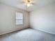 A carpeted bedroom with a window and neutral wall color at 10347 Heron Hideaway Loop, Land O Lakes, FL 34638