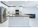 Open kitchen with granite countertops, stainless appliances, white cabinets, and a center island at 10347 Heron Hideaway Loop, Land O Lakes, FL 34638