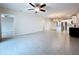 Open-concept living space featuring tile floors, a ceiling fan, and seamless flow to the kitchen at 10347 Heron Hideaway Loop, Land O Lakes, FL 34638