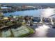 Aerial view of a community by a lake featuring a pool and tennis courts for active living in a peaceful neighborhood at 10412 White Lake Ct, Tampa, FL 33626