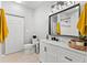 Stylish bathroom showcasing a white vanity with a marble countertop, sleek fixtures, and a large mirror at 10412 White Lake Ct, Tampa, FL 33626