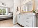 Bright bathroom with a vanity, stylish mirror, and a view into the bedroom for convenience at 10412 White Lake Ct, Tampa, FL 33626