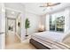 Comfortable bedroom with a ceiling fan, large window, and soothing decor, perfect for relaxation at 10412 White Lake Ct, Tampa, FL 33626