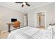 Bright bedroom features a ceiling fan, a desk with a computer, and a walk-in closet for ample storage at 10412 White Lake Ct, Tampa, FL 33626