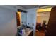 Bathroom features a sink, mirror, and lighting with a doorway view of the interior of the home at 1107 Goshen Rd, Tarpon Springs, FL 34689