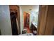 Bathroom with a sink vanity, mirror, and an adjacent walk-in closet and shower at 1107 Goshen Rd, Tarpon Springs, FL 34689