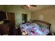 A bedroom with a ceiling fan, wardrobe and an open entrance to the hallway at 1107 Goshen Rd, Tarpon Springs, FL 34689