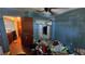 Bedroom showcases a connected closet and blue walls that provide a canvas for renovation ideas at 1107 Goshen Rd, Tarpon Springs, FL 34689