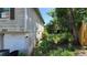 Exterior view displaying the backyard area, siding, and access to garage at 1107 Goshen Rd, Tarpon Springs, FL 34689