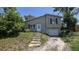 Two-story home featuring a quaint entryway and attached one car garage at 1107 Goshen Rd, Tarpon Springs, FL 34689