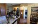 A kitchen leading to the pantry with a view of the staircase and living area beyond at 1107 Goshen Rd, Tarpon Springs, FL 34689