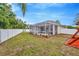 Expansive backyard featuring a screened-in porch, and a well-maintained lawn at 11123 Silver Dancer Dr, Riverview, FL 33579