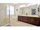 Bright bathroom with a soaking tub, a glass shower, and dual sinks at 11123 Silver Dancer Dr, Riverview, FL 33579