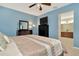 Bedroom featuring a large bed, dresser, and view into the bathroom at 11123 Silver Dancer Dr, Riverview, FL 33579