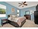 Comfortable bedroom with blue walls, a ceiling fan, and a spacious bed at 11123 Silver Dancer Dr, Riverview, FL 33579