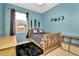 Blue bedroom featuring fun decorations, a window, and a cozy rug at 11123 Silver Dancer Dr, Riverview, FL 33579