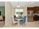 Bright breakfast nook with a round table, four chairs, and a window view at 11123 Silver Dancer Dr, Riverview, FL 33579