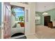 View from the open front door into a bright room with a large window, bookcase, and desk at 11123 Silver Dancer Dr, Riverview, FL 33579