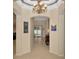 Elegant foyer featuring archways, a decorative chandelier, and neutral tiling at 11123 Silver Dancer Dr, Riverview, FL 33579
