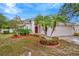 Charming single-story home with a well-manicured front yard and a red front door at 11123 Silver Dancer Dr, Riverview, FL 33579