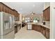 Modern kitchen with stainless steel appliances, dark wood cabinets, granite countertops, and an open layout at 11123 Silver Dancer Dr, Riverview, FL 33579