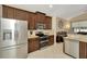 Spacious kitchen featuring stainless steel appliances and dark wood cabinets in an open layout at 11123 Silver Dancer Dr, Riverview, FL 33579