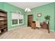 Home office featuring a desk, bookshelves, a large window with blinds, and ample natural light at 11123 Silver Dancer Dr, Riverview, FL 33579