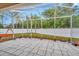 Screened patio featuring a tiled floor, an outdoor swing, and views of the backyard at 11123 Silver Dancer Dr, Riverview, FL 33579