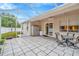 Screened patio with outdoor table, chairs, white fence, and view to the green backyard at 11123 Silver Dancer Dr, Riverview, FL 33579