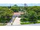 An elevated shot of home featuring mature landscaping, long driveway, and a terracotta-tiled roof at 11334 Winwood Pl # 11334, Port Richey, FL 34668
