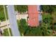 An aerial view of a single story home with mature landscaping and a tile roof at 11334 Winwood Pl, Port Richey, FL 34668