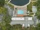 Overhead view of community clubhouse with pool, parking and surrounding greenery at 11334 Winwood Pl # 11334, Port Richey, FL 34668