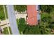 Aerial view showcases the home's roof, proximity to surrounding streets and mature trees at 11334 Winwood Pl, Port Richey, FL 34668
