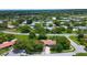 Aerial view of a suburban neighborhood showcasing single-story homes surrounded by lush greenery and mature trees at 11334 Winwood Pl # 11334, Port Richey, FL 34668