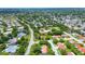 An aerial view of a suburban neighborhood with tree-lined streets and well-maintained homes at 11334 Winwood Pl # 11334, Port Richey, FL 34668