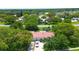 An aerial view of a single-story home with a driveway and mature trees in a suburban neighborhood at 11334 Winwood Pl # 11334, Port Richey, FL 34668