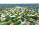 An aerial view showcases a community of single-story homes with mature landscaping and manicured lawns at 11334 Winwood Pl # 11334, Port Richey, FL 34668