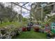 Lush backyard featuring many potted plants with a grass groundcover at 11334 Winwood Pl # 11334, Port Richey, FL 34668