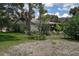 Rear exterior view shows a home with mature landscaping and an enclosed patio at 11334 Winwood Pl # 11334, Port Richey, FL 34668