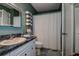 Bathroom featuring vanity with solid countertops, mirror, and shower with curtain at 11334 Winwood Pl # 11334, Port Richey, FL 34668