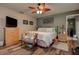 This cozy bedroom offers a comfortable space with a ceiling fan, wood-look floors, and peaceful decor at 11334 Winwood Pl # 11334, Port Richey, FL 34668