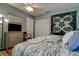 This sun-lit bedroom is furnished with a comfortable bed, ceiling fan, and warm wood-look floors at 11334 Winwood Pl # 11334, Port Richey, FL 34668
