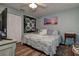 Well-lit bedroom with a comfortable bed, ceiling fan, wood-look floors, and natural light at 11334 Winwood Pl # 11334, Port Richey, FL 34668