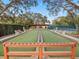 Well-maintained bocce ball court surrounded by trees and benches at 11334 Winwood Pl # 11334, Port Richey, FL 34668
