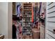 This walk-in closet features custom shelving for ample storage of clothes, shoes, and accessories at 11334 Winwood Pl # 11334, Port Richey, FL 34668