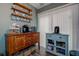 Cozy coffee bar area with decorative mugs on shelves, wooden cabinets, and hardwood style flooring at 11334 Winwood Pl # 11334, Port Richey, FL 34668