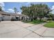 Single story home with well-manicured lawn, two car garage, and mature landscaping at 11334 Winwood Pl # 11334, Port Richey, FL 34668